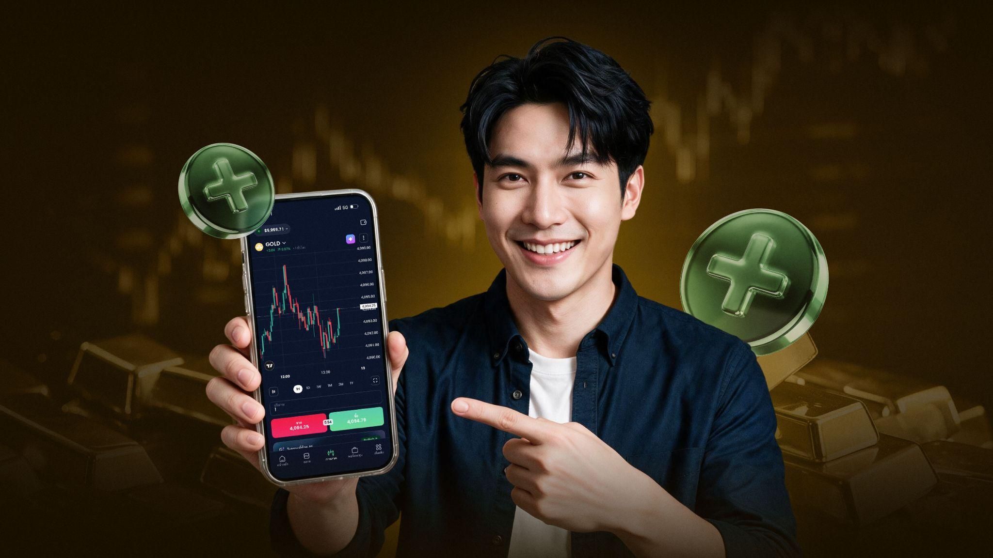 Trader holding phone showing gold price chart on XM trading app