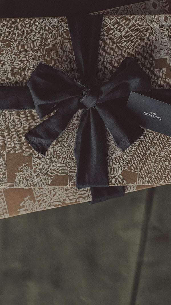 TS Product Packaging with a Black Gift Ribbon knotted around.