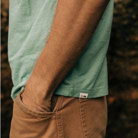 fit model posing with his hands in his pockets wearing The Cotton Hemp Tee in Teal