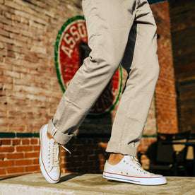 fit model in low-top canvas shoes with The Democratic Foundation Pant in Organic Stone