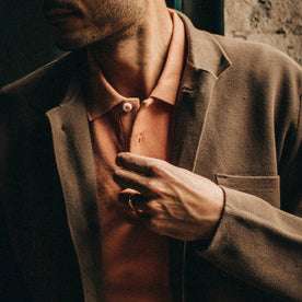 fit model wearing The Pique Polo in Coral, Prout layered over