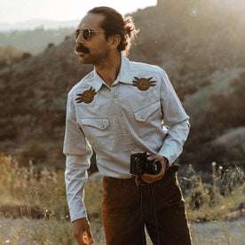 fit model holding a camera in The Embroidered Western Shirt in Washed Selvage