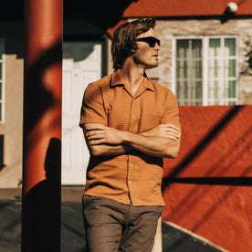 fit model standing in The Short Sleeve Hawthorne in Rust Pickstitch Waffle
