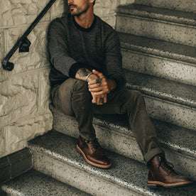 fit model wearing The Slim All Day Pant in Espresso Cord, sitting on steps