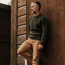 fit model wearing The Wharf Sweater in Dark Olive looking out