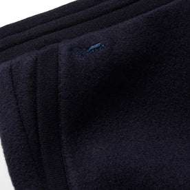 Material shot of The Weekend Pant in Navy Boiled Wool showing the embroidery 