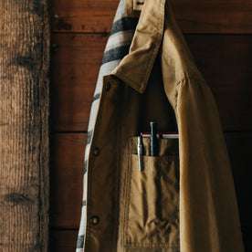 editorial image of The Lined Longshore Jacket in Harvest Tan Waxed Canvas hanging