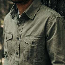 fit model showing off the pockets on The Saddler Shirt in Washed Olive