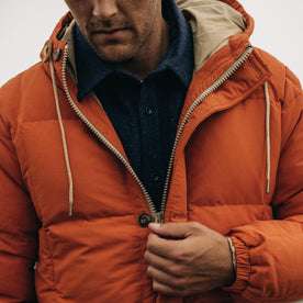 fit model zipping up The Whitney Parka in Dusty Orange