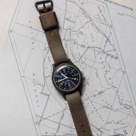 flatlay of the 1991 Timex Camper on a map
