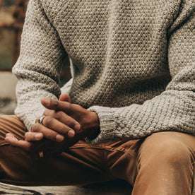 fit model wearing The Fisherman Sweater in Heather Ash, hands clasped