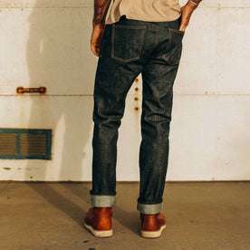 fit model wearing The Slim Jean in Natural Indigo Selvage, shown from the back