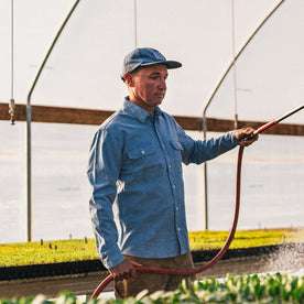 fit model at The Ecolofy Center watering plants in The Chore Shirt in Washed Indigo Boss Duck