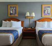 ห้องนอน 3 Days Inn & Suites by Wyndham Orlando East UCF Area