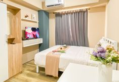 Bedroom 2 Soft Minimalist Studio Room at Apartment Meikarta By Travelio