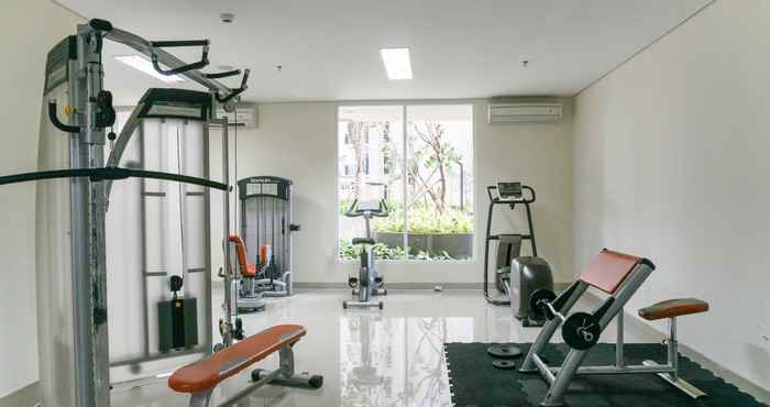 Fitness Center Modern 1BR at Puri Orchard Apartment By Travelio