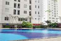 Swimming Pool Cozy & Best Price 3BR at Bassura City Cipinang Apartment By Travelio