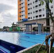 Swimming Pool 2 Fully Furnished 1BR Apartment at Green Pramuka By Travelio