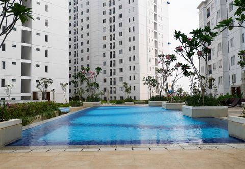 Swimming Pool Stylish and Comfy 2BR Bassura City Apartment By Travelio