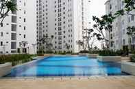 Swimming Pool Stylish and Comfy 2BR Bassura City Apartment By Travelio