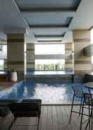 SWIMMING_POOL Homey and Modern 2BR Apartment at Maqna Residence By Travelio