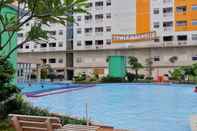 Swimming Pool Cozy 2BR Connected to Mall Apartment at Green Pramuka City By Travelio