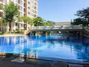 Swimming Pool 4 Minimalist and Cozy 2BR Apartment at East Coast Residence By Travelio