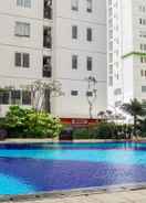 SWIMMING_POOL Chic and Homey 2BR Apartment at Bassura City By Travelio