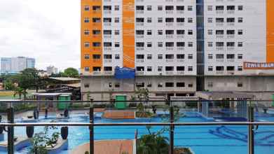 Swimming Pool 4 Warm and Comfy 2BR Green Pramuka Apartment near Mall By Travelio