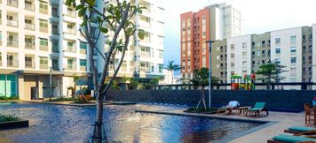 Swimming Pool 2 Simply Spacious 1BR at Green Bay Condominium Apartment By Travelio