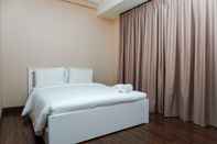 Bedroom Homey 1BR Puri Orchard Apartment By Travelio