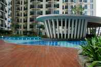 Swimming Pool Homey 1BR Puri Orchard Apartment By Travelio