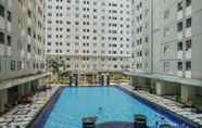 Swimming Pool 6 Homey Emerald 2BR Gading Nias Residences Apartment By Travelio