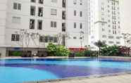 Swimming Pool 5 2BR Simply Living at Bassura City Apartment By Travelio