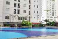 Swimming Pool 2BR Simply Living at Bassura City Apartment By Travelio