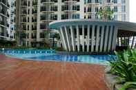 Swimming Pool 2BR Comfy Puri Orchard Apartment By Travelio