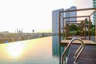 Kolam Renang 2BR Modern Grand kamala Lagoon Apartment By Travelio