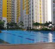 Swimming Pool 6 Modern 3BR Apartment at Springlake Summarecon Bekasi By Travelio