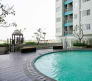 Swimming Pool 4 Studio Furnished with City View at The Nest Apartment By Travelio