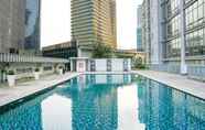 Swimming Pool 5 Modern 2BR Apartment at The Masterpiece Condominium Epicentrum By Travelio