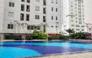 Swimming Pool 2 Bassura City 2BR Apartment with Nice Interior Design By Travelio