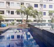 Swimming Pool 3 Minimalist 2BR Titanium Square Apartment By Travelio