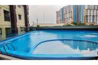 Swimming Pool Minimalist Studio Apartment at Atria Residences with Pool View By Travelio