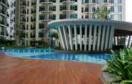 Swimming Pool 2 Minimalist New Furnished 1BR at Puri Orchard Apartment By Travelio