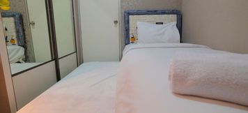 Bedroom 2 Emerald 2BR Apartment Gading Nias By Travelio