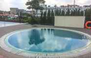 Swimming Pool 3 Homey and Warm Studio at The Oasis Cikarang Apartment By Travelio