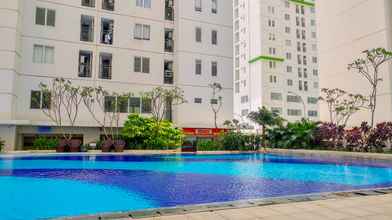 Swimming Pool 4 Cozy 2BR with Mall Access at Bassura City Apartment By Travellio