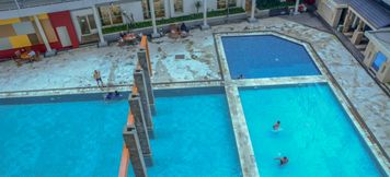 Swimming Pool 5 Simply and Cozy 2BR Gardenia Boulevard Apartment By Travelio