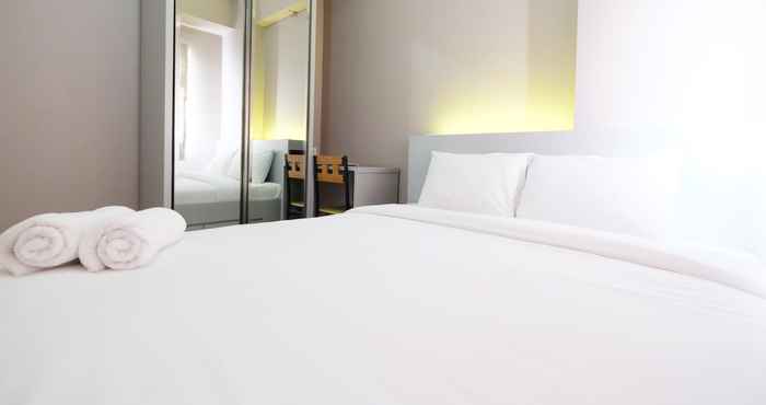 Bedroom Homey 2BR with Mall Access at Green Pramuka City Apartment By Travelio