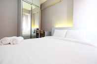 Bedroom Homey 2BR with Mall Access at Green Pramuka City Apartment By Travelio